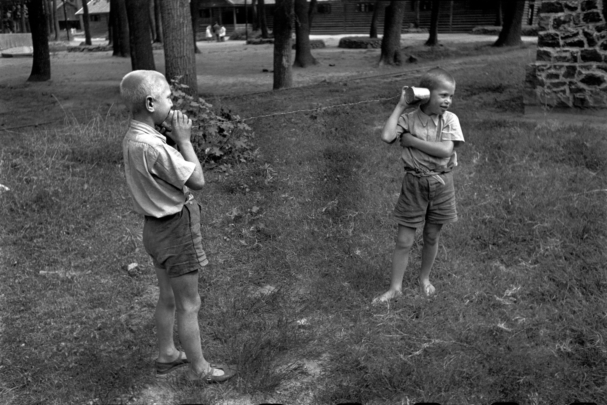 Picture of two boys playing with a tin can telephone in the Children's Town at Hajduhadhaz, taken in 1948 by David Seymour.