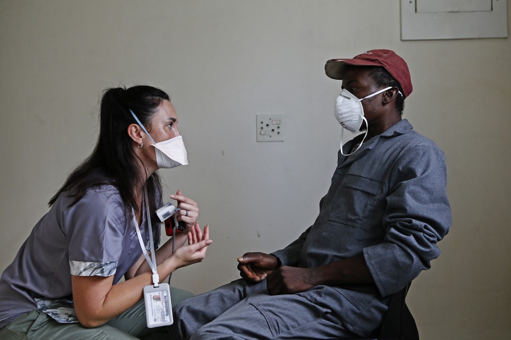 A consultation at the Lyttelton Sports Centre in Pretoria on 16 April 2020 where temporary shelter is being provided for homeless people amid the COVID-19 coronavirus situation in South Africa. By photographer Phill Magakoe / AFP