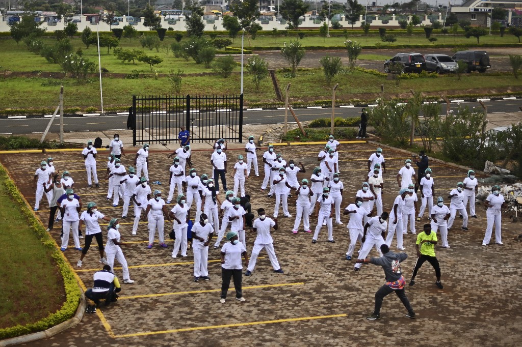 Nurses assigned to the Infectious Diseases Unit (IDU) at the Kenyatta University Hospital attend a Zumba class held at the hospital compound in Nairobi, on 17 May 17 2020. Coinciding with the morning shift rotation, it aimed to offer some respite to nurses charged with the management of patients infected with COVID-19 coronavirus. By Tony Karumba / AFP