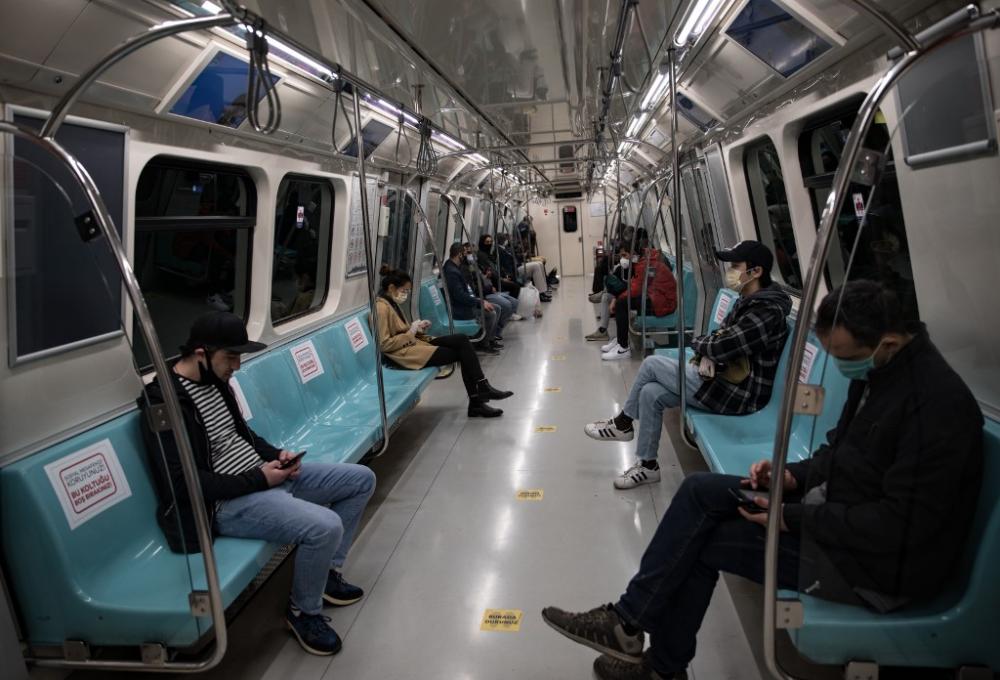 People wearing a face mask sit on the metro while respecting social distancing in Istanbul, Turkey, on 7 May 2020. By Cem Tekkeşinoğlu / AFP.