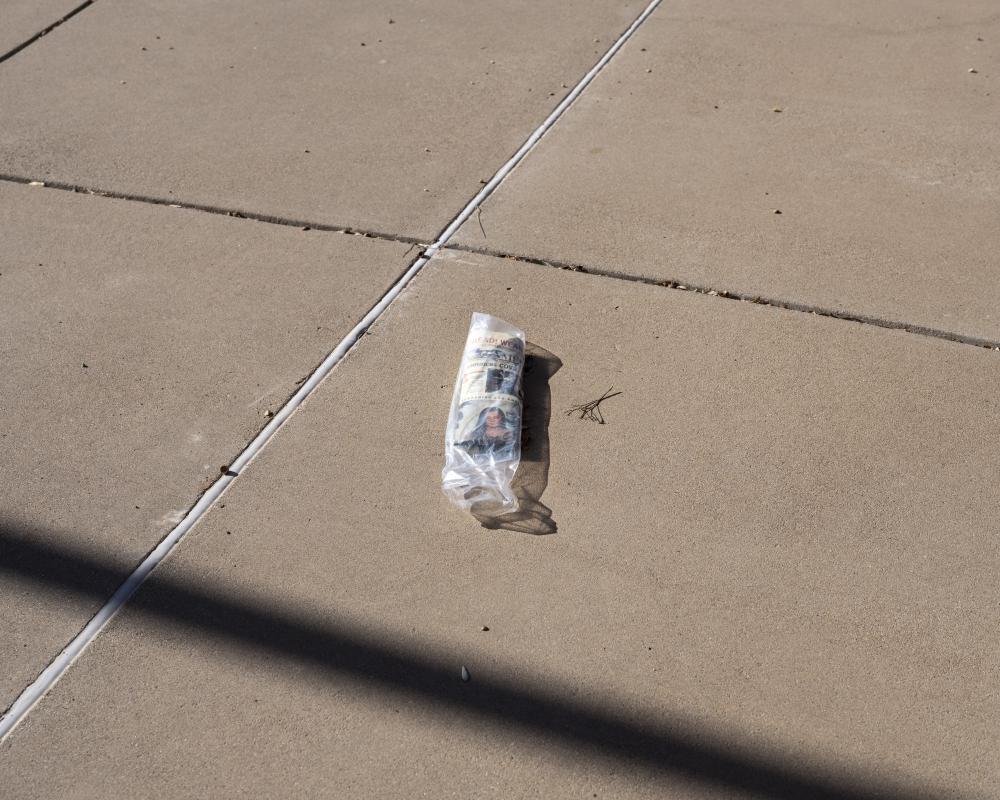 This newspaper wrapped up in a plastic bag was taken in front of the Presidential Museum and Leadership Library, Odessa, the USA, by Lorenzo Meloni, in 2020
