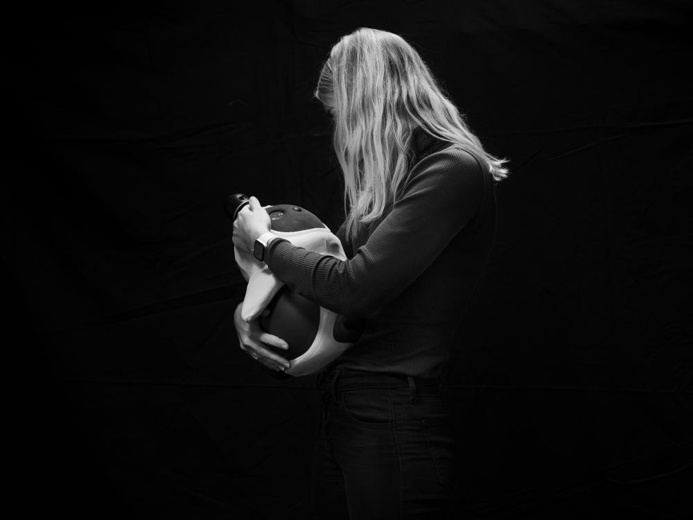 The photographer Olivia Arthur pictured this woman holding the social robot called "LOVOT," a generation of robots with advanced artificial intelligence to nurture love, at Aalborg University, Denmark in 2021