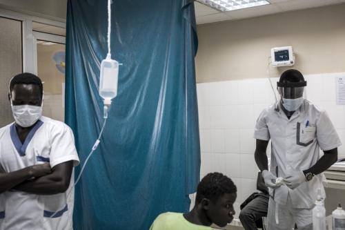 The picture above was taken at the emergency ward in Pikine Hospital in Dakar, Senegal on April 23, 2020. Hospitals are preparing to receive and test suspect cases whilst safely treating their normal patients. By photographer John Wessels /AFP. 